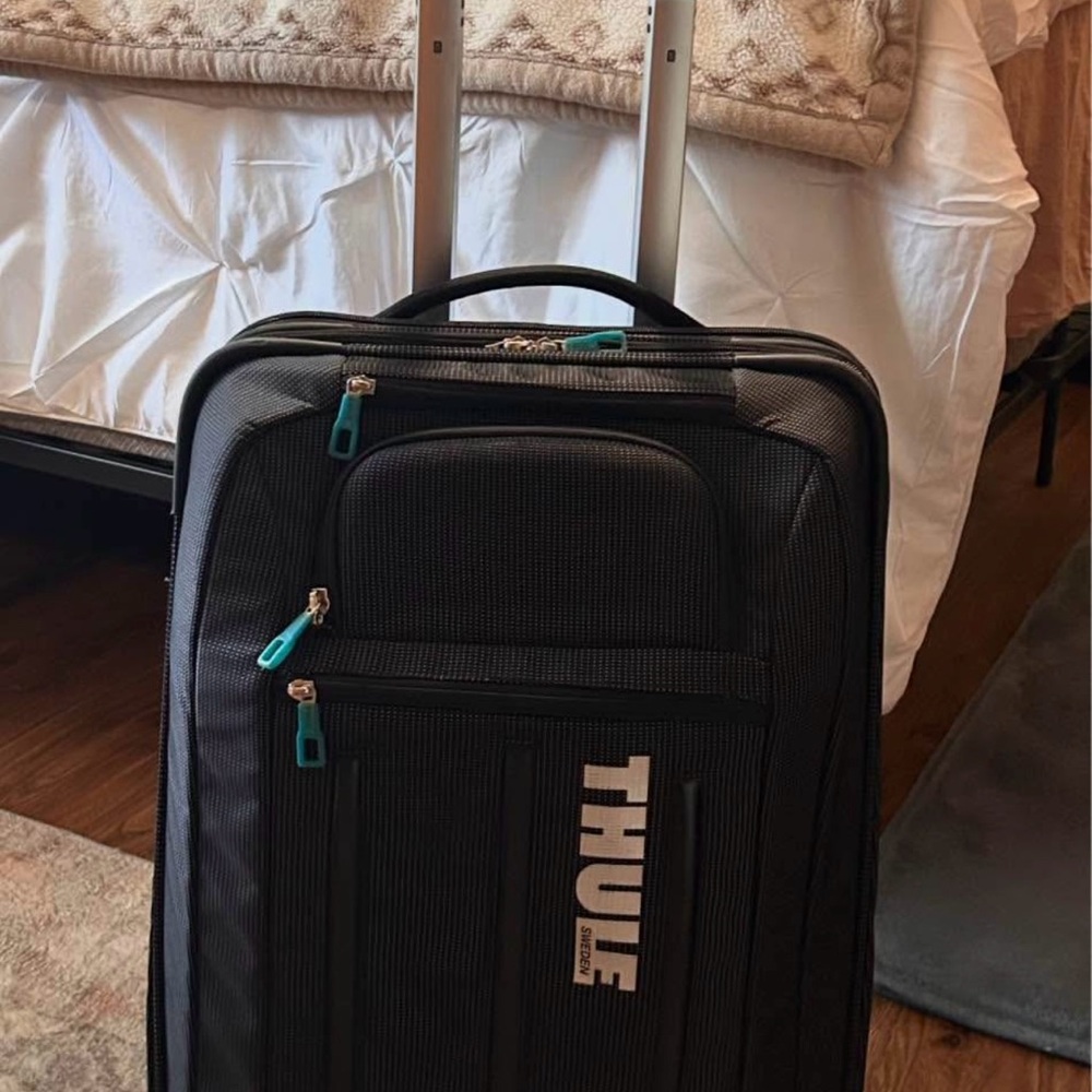 Thule Black Suitcase with Teal Accents